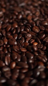 Rotating camera shot over a full frame background of roasted coffee beans