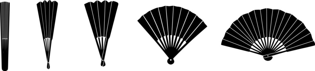 Collection of traditional black handheld folding fans in various open positions on white background © Sarfaraz