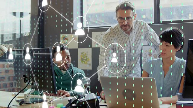 Team leaning at laptop, standing man pointing and expanding network overlay for tech analysis