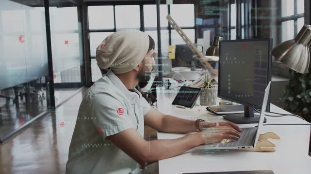 Developer typing at bench with laptop, glancing as coworker appearing, code overlay marking edits