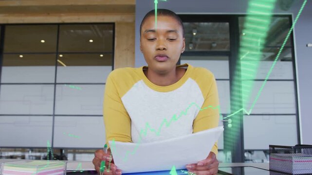 Female host reading sheet and pointing while green financial charts overlaying papers to explain