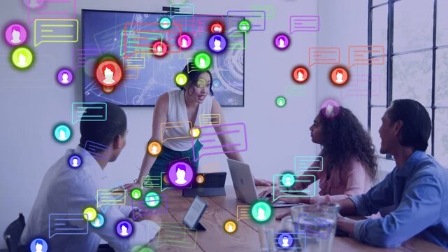 Business presenter walking to head, presenting update while chat bubbles floating across devices