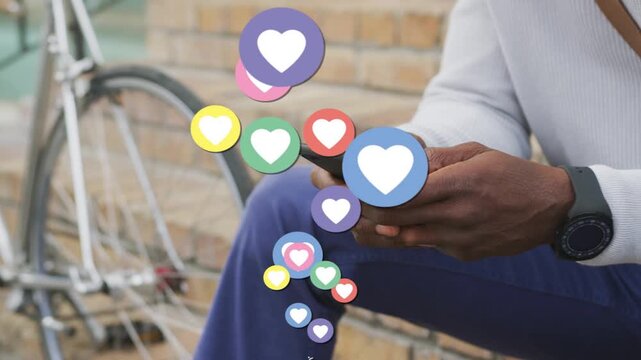 Man tapping smartphone on bench, initiating animated hearts rising past hands for social marketing