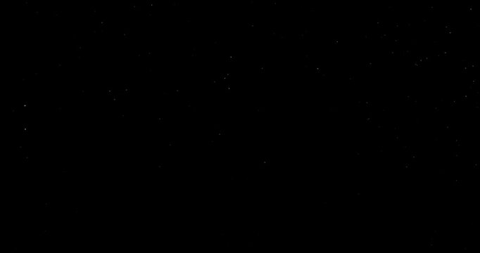 Super slow motion falling snow or dust particles isolated on a black background. Abstract atmospheric SFX overlay with floating debris, cinematic texture and dark visual effect.