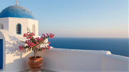 Fototapeta premium Blue-domed church pink flowers white walls overlooking the sea.
