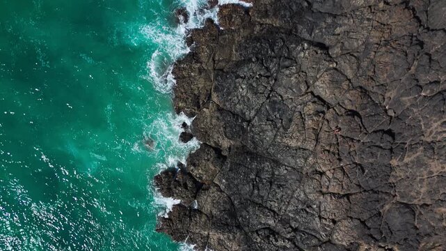 Aerial Top Down View of Waves Crashing on Volcanic Rocks in El Cotillo Fuerteventura