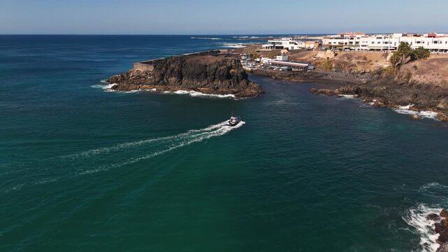 Aerial View of Fishing Boat Entering El Cotillo Harbour in Fuerteventura Spain