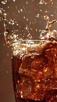 Ice cubes fall into a glass with cola. Filmed is slow motion 1000 fps. High quality FullHD footage