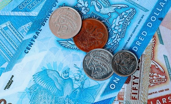 Trinidad and Tobago dollar money bills and coins on table. Trinidad and Tobago cash of TTD currency