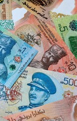 Brunei dollar money banknotes bunch on table. Brunei bills of BND currency close up © Larysa
