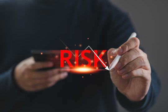 Business risk management concept with declining arrow and red warning text, hand using stylus and smartphone analyzing loss, financial downturn, crisis strategy, uncertainty control, decision making