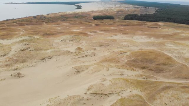 An aerial, high angle shot of the vast Parnidis sand dune landscape on the Curonian Spit, near the village of Nida, Lithuania.