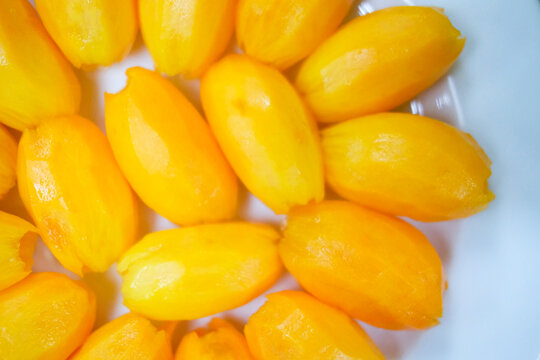 Peeled Plum mango or Kundang fruit on plate