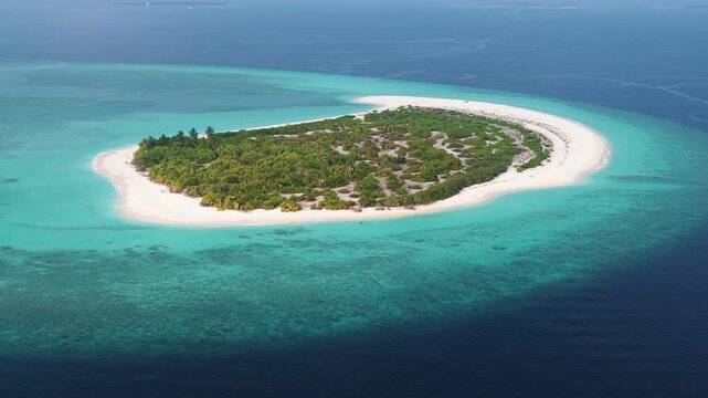 Aerial view of luxury overwater bungalows and wooden walkways over a crystal clear turquoise lagoon near Hoarafushi, Haa Alif Atoll, Maldives.