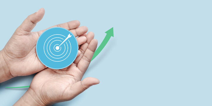 Hands Protecting Target Goal Symbol with Upward Growth Arrow in Clean Business Environment Representing Strategic Success Achievement Financial Progress Motivation and Future Business Expansion