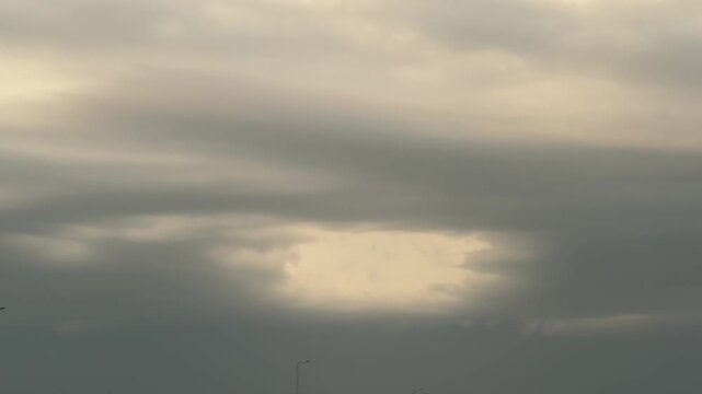Light breakdown through dramatic storm clouds cinematic overcast sky window loopable background
