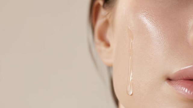 Macro close up of glowing cosmetic serum on woman skin with copy space, luxury skincare treatment and beauty wellness concept.