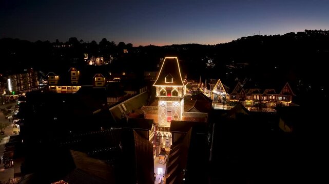 Night View Of Capivari Village In Campos Do Jordao In Sao Paulo Brazil. Illuminated Ferris Wheel. Downtown Cityscape. European Architecture. Capivari Village In Campos Do Jordao In Sao Paulo Brazil. 
