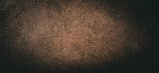 Fototapeta premium Dark, rustic abstract background with a textured, earthy surface and a moody, vignette-style lighting effect.