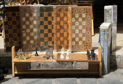 Collection of traditional handmade wooden chess boards and chess pieces and Lebanese Tawleh displayed outside a souvenir shop in Byblos, Lebanon.