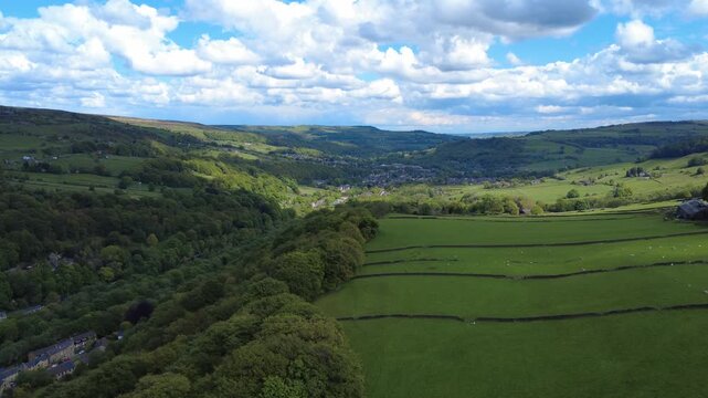 High aerial view of the Calder valley showing the end of Hebden Bridge and Mytholmroyd in the distance surrounded by west yorkshire landscape