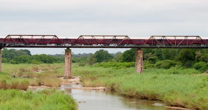 Scenic safari accommodation in Kruger National Park, South Africa. Handheld wide shot of Kruger Shalati luxury train hotel permanently parked on the historic Selati Bridge above Sabie River