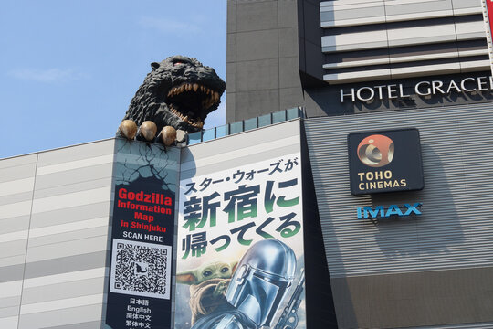 TOKYO, JAPAN - May 20, 2026: A large statue of Godzilla on a Toho movie theater in Shinjuku which has a poster for The Mandalorian and Grogu on it.
