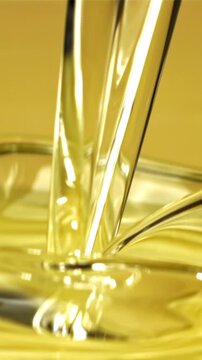 Olive oil with splashes on yellow background. Filmed on a high-speed camera at 1000 fps. High quality FullHD footage