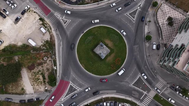 Aerial view of cars driving around a roundabout topdown view