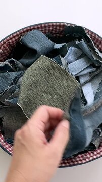 Hands Holding Upcycled Denim Fabric Strips in Handmade Sewing Basket

