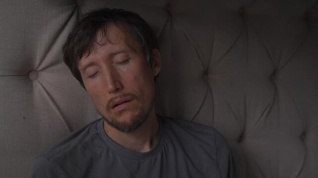 Middle aged man sleeping and snoring, high quality uncompressed audio recording. Natural night rest with breathing sounds. Everyday life, sleep routine and human physiology concept.