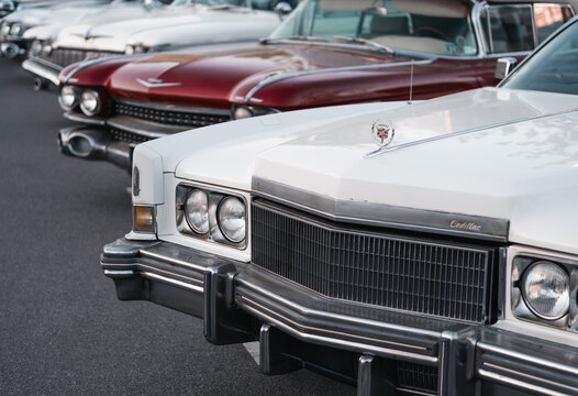 Four Cadillac Eldorados of different generations. Horizontal image of 1960s-1970s land yacht cars in parking lot at golden hour - local car meet. Kyiv, Ukraine - May 16 2026