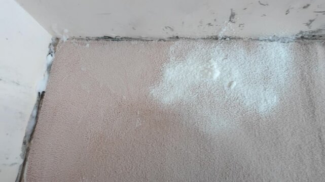 Wall surface being repaired with plaster at interior ceiling corner