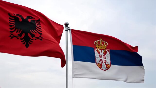 albanian and serbian flag waving in the sky. relations albania serbia