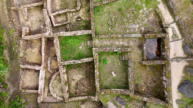 Aerial view of Castro de Armea archaeological site featuring ancient stone walls and green vegetation in Allariz, Province of Ourense, Spain.