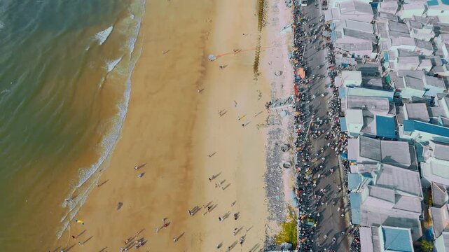 Aerial perspective: Coastal parade and crowd at Phuoc Hai seawall, Vietnam