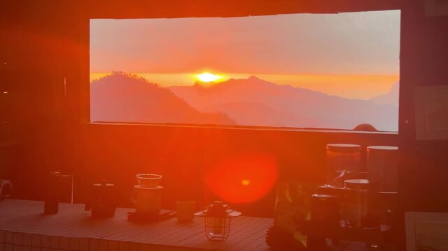 A balcony view with drip coffee equipment on a sunrise over the mountain in Thailand.