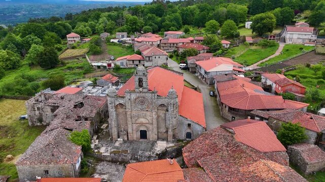 Aerial view of Iglesia de Santa Marina de Augas Santas with its red tiled roofs and stone walls in the historic village of Augas Santas, Ourense, Spain.
