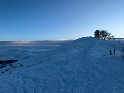 on the snow-capped peak of Mount Mottarone, Clouds moving in the valley at sunset.