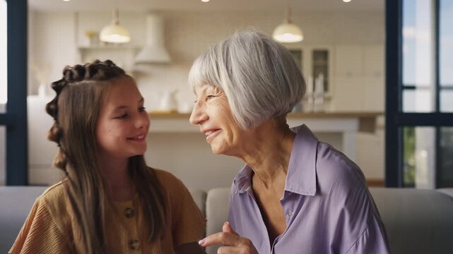 Girl sharing secrets with her granny, trusting family relationship, friendship