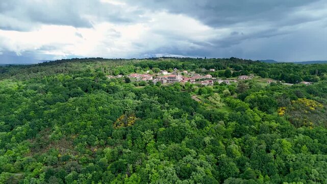 Aerial view of Iglesia de Santa Marina de Augas Santas surrounded by dense green forest and rolling hills in Augas Santas, Ourense, Spain.