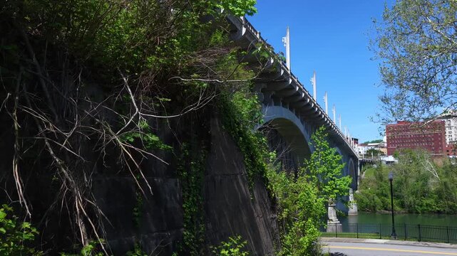 Beautiful Arched bridge crossing peaceful southern river in Fairmont, West Virginia on summer day 