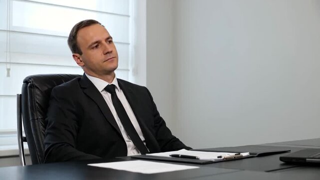 Professional Businessman in Suit Reviewing Documents at Desk, Approving Contracts,