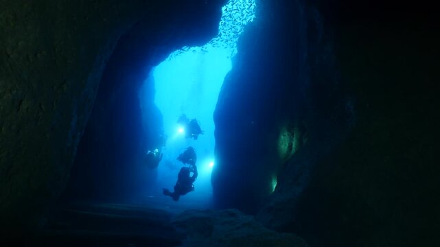 scuba divers exploring caves underwater cave diving