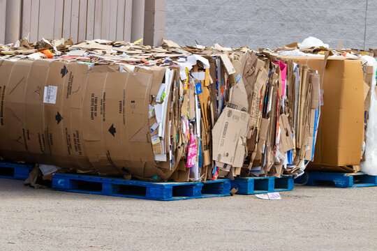 Compressed recycled paper and cardboard waste