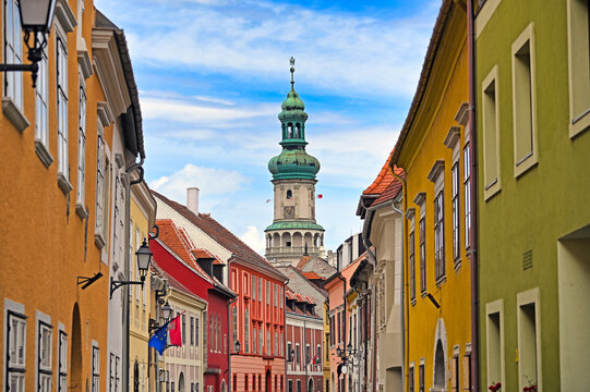 Firewatch Tower or Tuztorony Framed by Colorful Old Town Street Facades in Sopron Hungary