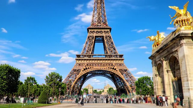 Iconic Eiffel Tower in Paris, centered from Trocad&eacute;ro Gardens, framed by neoclassical Palais de Chaillot with golden statues under azure sky. Bright daylight, deep focus, timeless Parisian cityscape