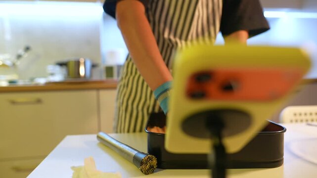 Modern kitchen scene showcasing food creator shaping base carefully