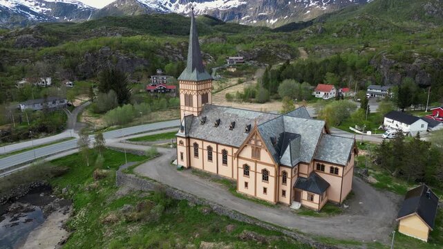 Beautiful Vagan church, also known as Lofoten Cathedral, situated in Kabelvag in the Lofoten Islands, Norway, against a stunning mountain backdrop