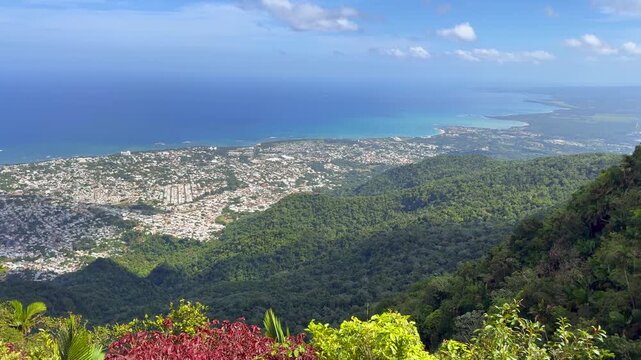 Scenic landscape view of the coastline of Puerto Plata in the Dominican Republic seen from Mount Isabel de Torres. Panning left to right. 